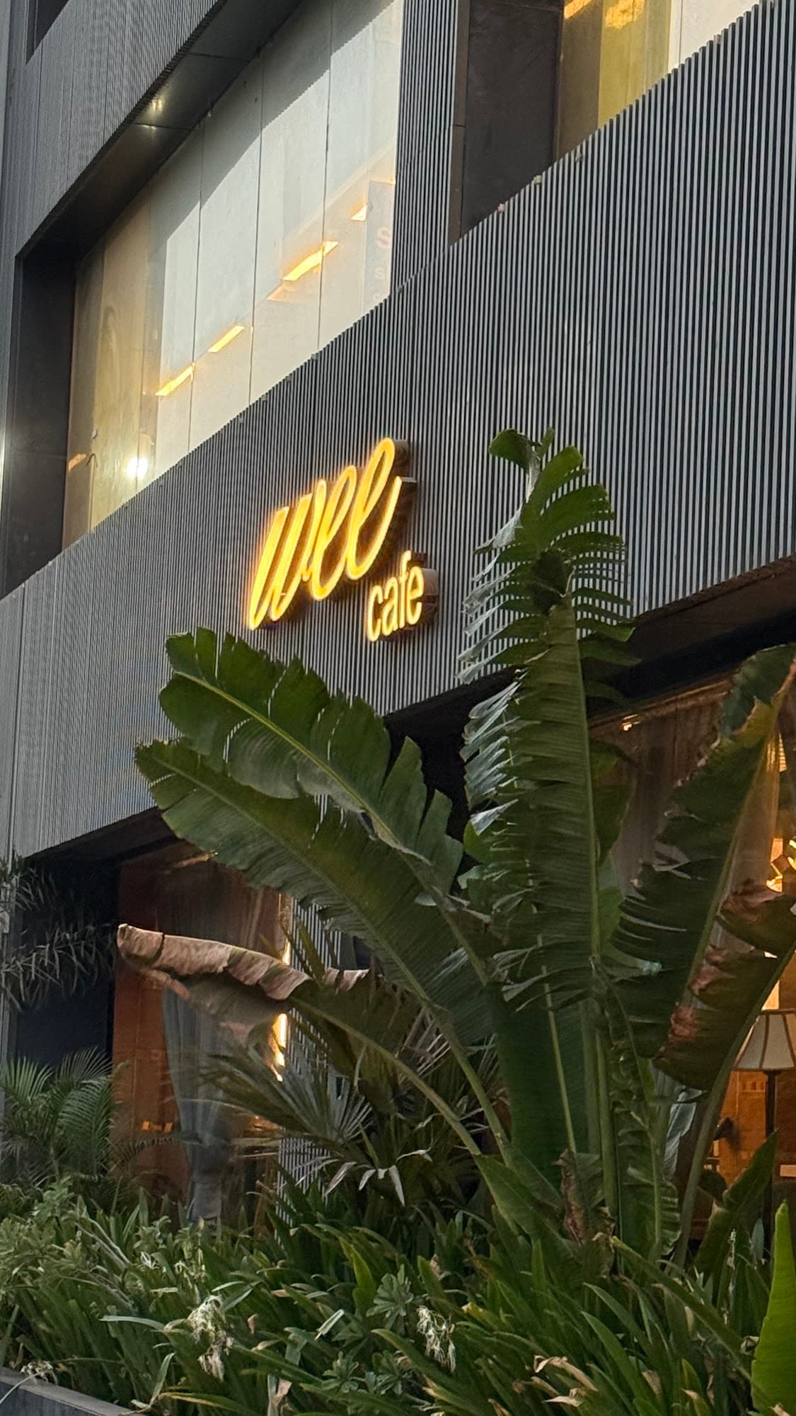 Wee Café neon sign at night